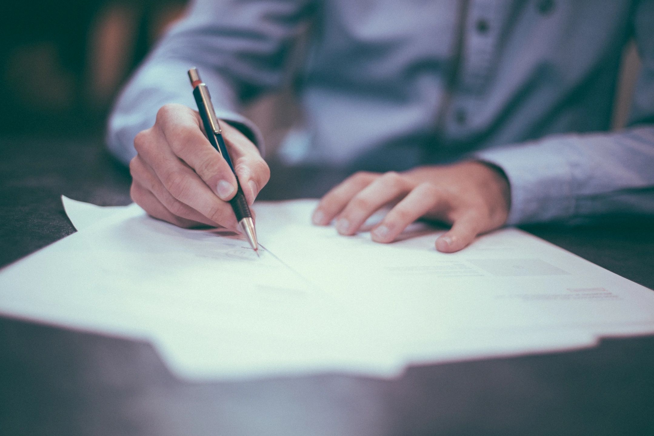 Professional signing a business document